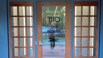 A wooden double door with glass panels and a number '1170' on the glass.