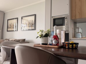 A modern kitchen with a microwave, oven, and blender. - Riviera Château de Rêve - Phoenix's Gîte @ Ellipse Waterfall. (Midrand)