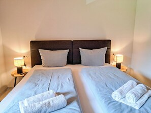 A double bed with two pillows and two bedside lamps. - Adlerhorst by Interhome (Auffach)
