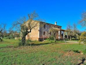 A two-story stone building with a tiled roof, surrounded by a grassy field and trees. - Cabin in Buger With Swimming Pool (Buger)