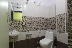 A bathroom with a mosaic tile wall, a sink, a toilet, and a shower. - Hotel O V R Residency Near Sri  (Bangalore)