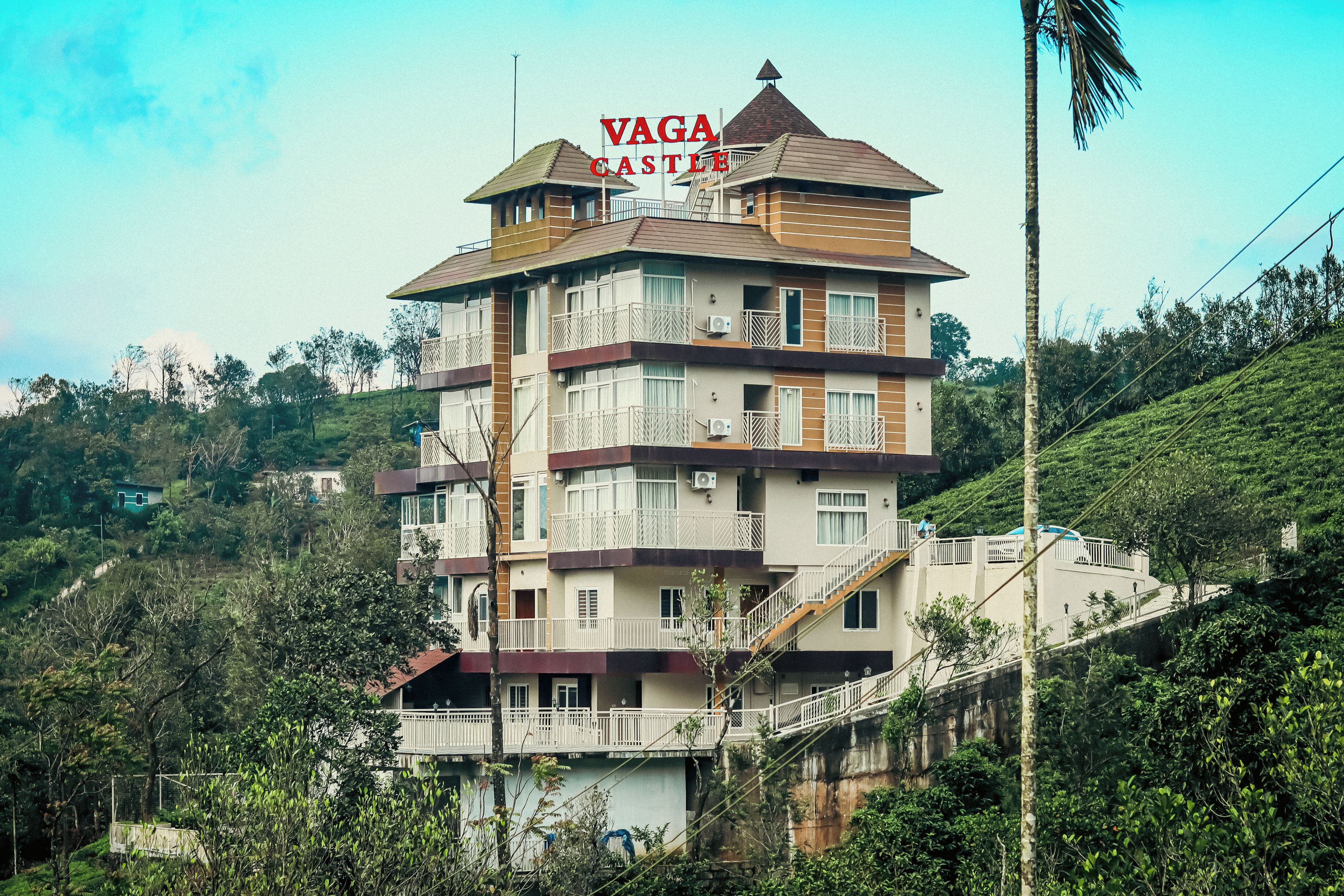 A multi-story hotel with balconies and a sign reading 'VAGA CASTLE'.