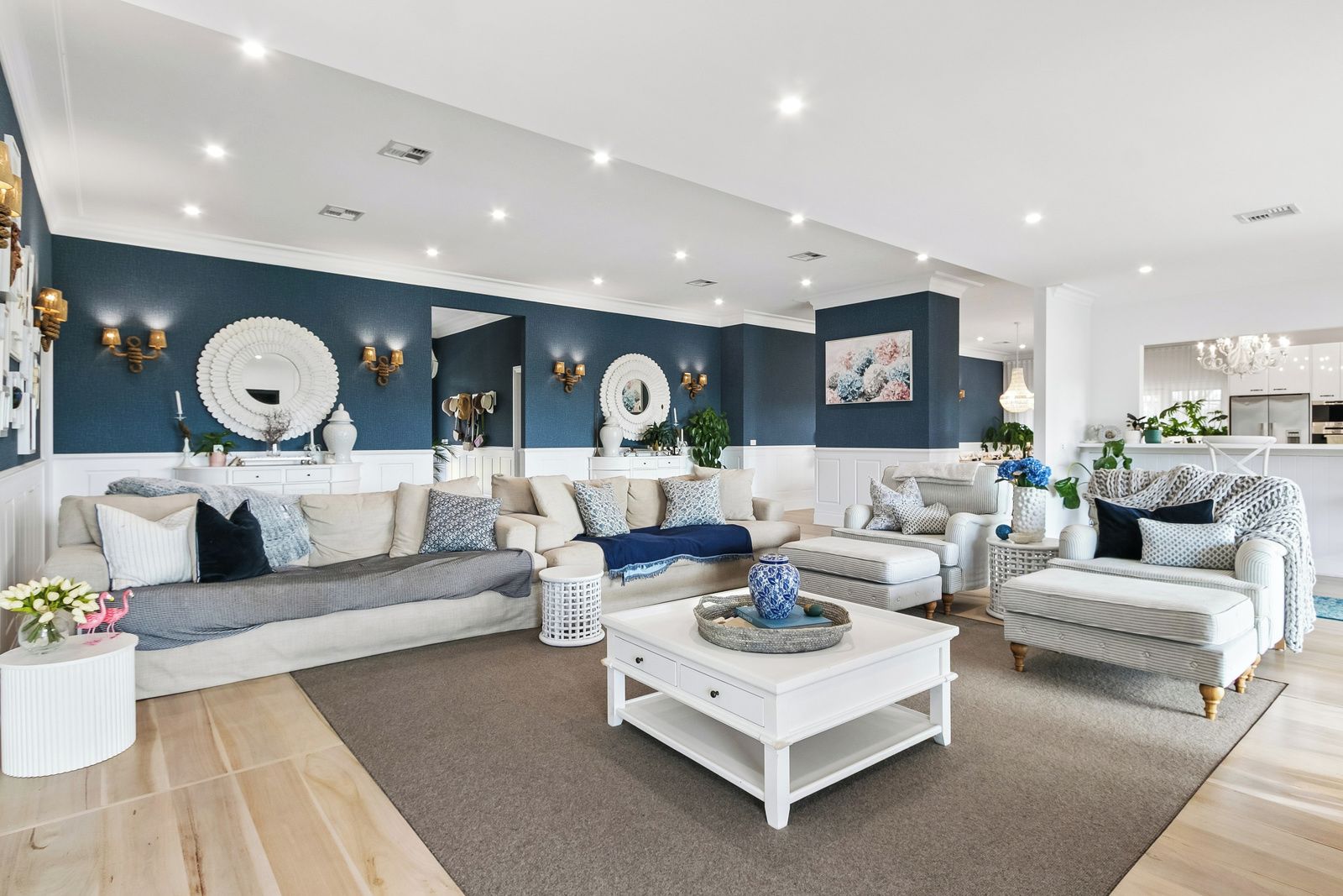 A modern living room with a sectional sofa, a coffee table, and a patterned rug.