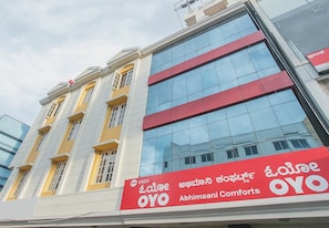 A building with a red and white sign for Abhimaani Comforts. - Hotel O ABHIMAANI COMFORTS (Bangalore)