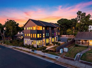 A multi-story residential building with a flat roof, multiple windows, and a visible front porch. - 4 Modern Townhomes | Balconies | Walk to Cafés + Shops | Lischey Full Buyout (Nashville)