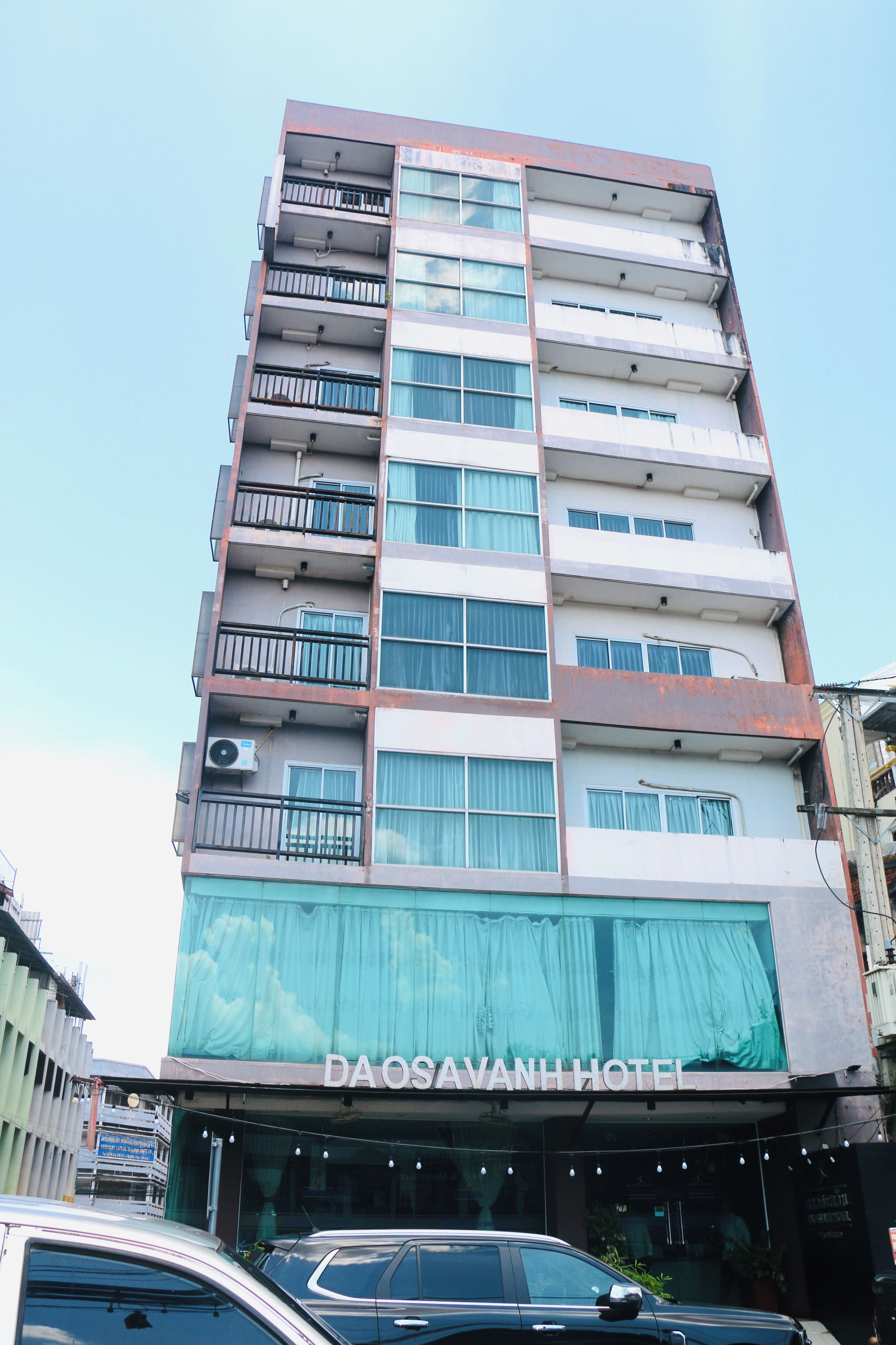 A multi-story building with a sign for DAOSAVANH HOTEL.