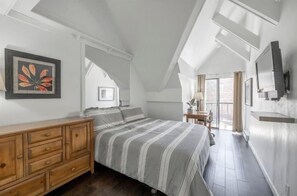 A bedroom with a bed, wooden dresser, and a TV on the wall. - Lodge at Mtn Village A303 | Ski-In/Ski-Out | PCMR Base | Pool | Hot Tub | Mtn Views | Fireplace (Park City)