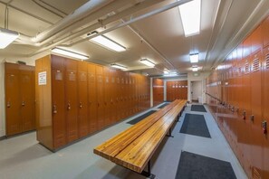 A locker room with multiple wooden lockers, a bench, and a tiled floor. - Lodge at Mtn Village A303 | Ski-In/Ski-Out | PCMR Base | Pool | Hot Tub | Mtn Views | Fireplace (Park City)