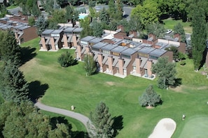 A residential complex with multiple apartment buildings, green lawns, and trees. - Park Ave 243 | Heated Pool | Hot Tub | Trail-Side by Golf Course | Walk to Shops & Dining (Park City)
