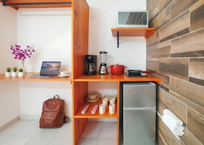 A compact kitchenette with a microwave, coffee maker, blender, and a small refrigerator. - Easy Mornings. 5th Ave, ADO, Cozumel Ferry & Beach 4 Mins · Memory Foam King Bed (Playa del Carmen)