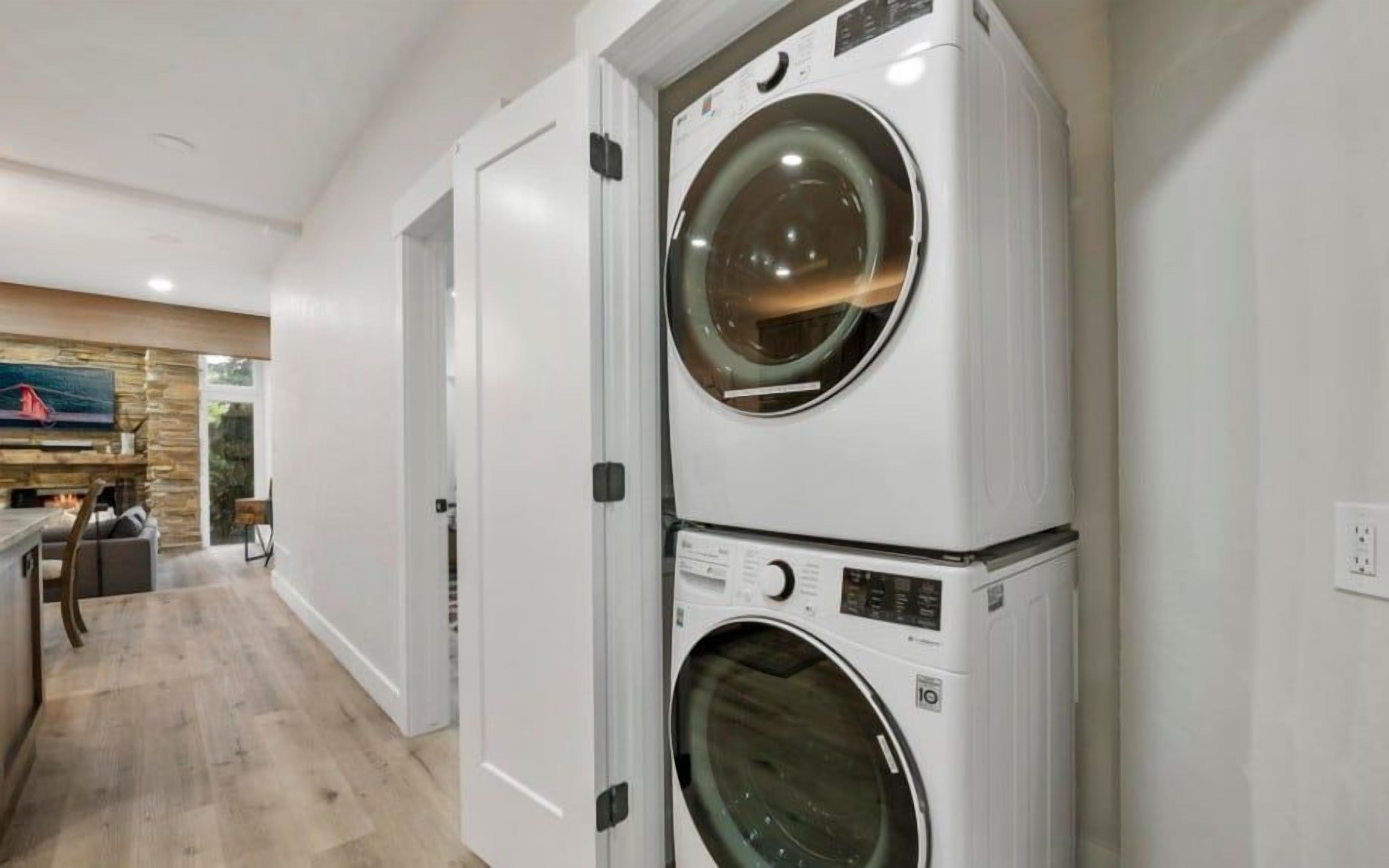 A laundry room with two stacked front-loading washing machines.