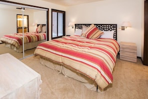 A bedroom with a large bed, a bedside table, a nightstand, a mirror, and a window with blinds. - Three Kings 37 | Walk to Three Kings Lift | Heated Pool | Hot Tub | Sauna | Garage Parking (Park City)