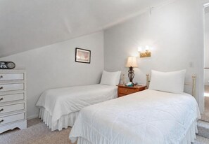 A bedroom with two single beds, a dresser, a bedside table with a lamp, and a framed picture on the wall. - Three Kings 41 | Walk to Three Kings Lift | Heated Pool | Hot Tub | Sauna | Updated | Free Bus (Park City)