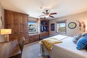 A bedroom with a bed, a desk, a chair, a ceiling fan, and a window. - Resort Center 5002 | Ski-In/Ski-Out | Pool & Hot Tub Access | Fireplace | A/C | Granite Kitchen (Park City)