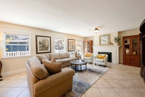 A living room with a beige sofa, a coffee table, and a fireplace. - Resort Center 5004 | Ski-In/Ski-Out | Pool & Hot Tub Access | Fireplace | Elevator | 1,700 Sq Ft (Park City)