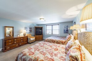 A bedroom with two beds, a dresser, a television, and a window with blinds. - Resort Center 5030 | Ski-In/Ski-Out | Pool & Hot Tub Access | Balcony w/ Ski Run Views | Fireplace (Park City)