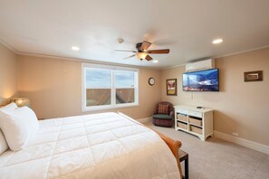 A bedroom with a bed, a ceiling fan, a window, a television, and a small cabinet. - Resort Center 5052 | Ski-In/Ski-Out | Pool & Hot Tub Access | Mtn View Deck | Fireplace | A/C (Park City)