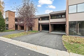 A building with a parking lot, a tree, and a clear sky. - Park Ave 296 | Heated Pool | Hot Tub | Renovated | Stone Fireplace | Next to Golf Course | Free Bus (Park City)