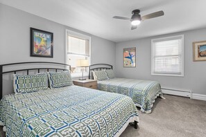 A bedroom with two beds, a ceiling fan, and artwork on the walls. - Resort Center 5025 | Ski-In/Ski-Out | Pool & Hot Tub Access | Renovated Baths | Fireplace | Roku (Park City)