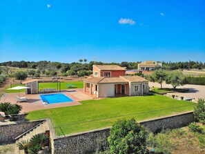 A two-story house with a swimming pool, a stone staircase, and a well-maintained lawn. - Cabin in Muro With Swimming Pool (Muro)