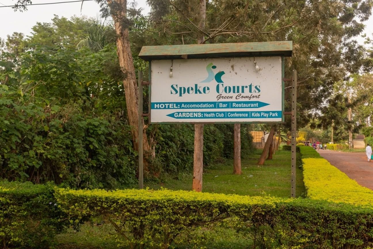 A sign for Speke Courts with amenities including a hotel, bar, restaurant, health club, conference, and kids play park.