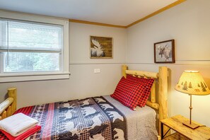 A bedroom with a single bed, a window with blinds, a lamp, and two framed pictures on the wall. - 1/2 Mi to Marina! Lake George Group Getaway (Diamond Point)