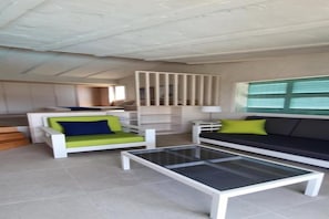 A modern living room with a sofa, armchair, and glass coffee table. - Casas Carmen (San Bartolomé de Tirajana)