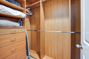 A wooden wardrobe with multiple compartments and a hanging space. - Large Patio Oasis, Games, Pool! Indio Getaway (Indio)