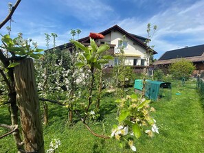 A residential area with a house, a wooden fence, and a grassy yard. - Idyllic vacation rental with a south-facing balcony for up to 6 people (Lindau (Bodensee))