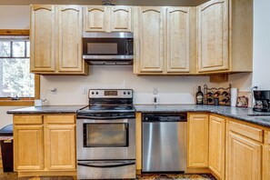 A kitchen with wooden cabinets, a stainless steel stove, a microwave, and a dishwasher. - Retreat 7 Mi to Northstar Skiing! Easy I-80 Access (Truckee)