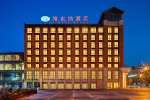 A multi-story hotel building with a prominent sign at the top.