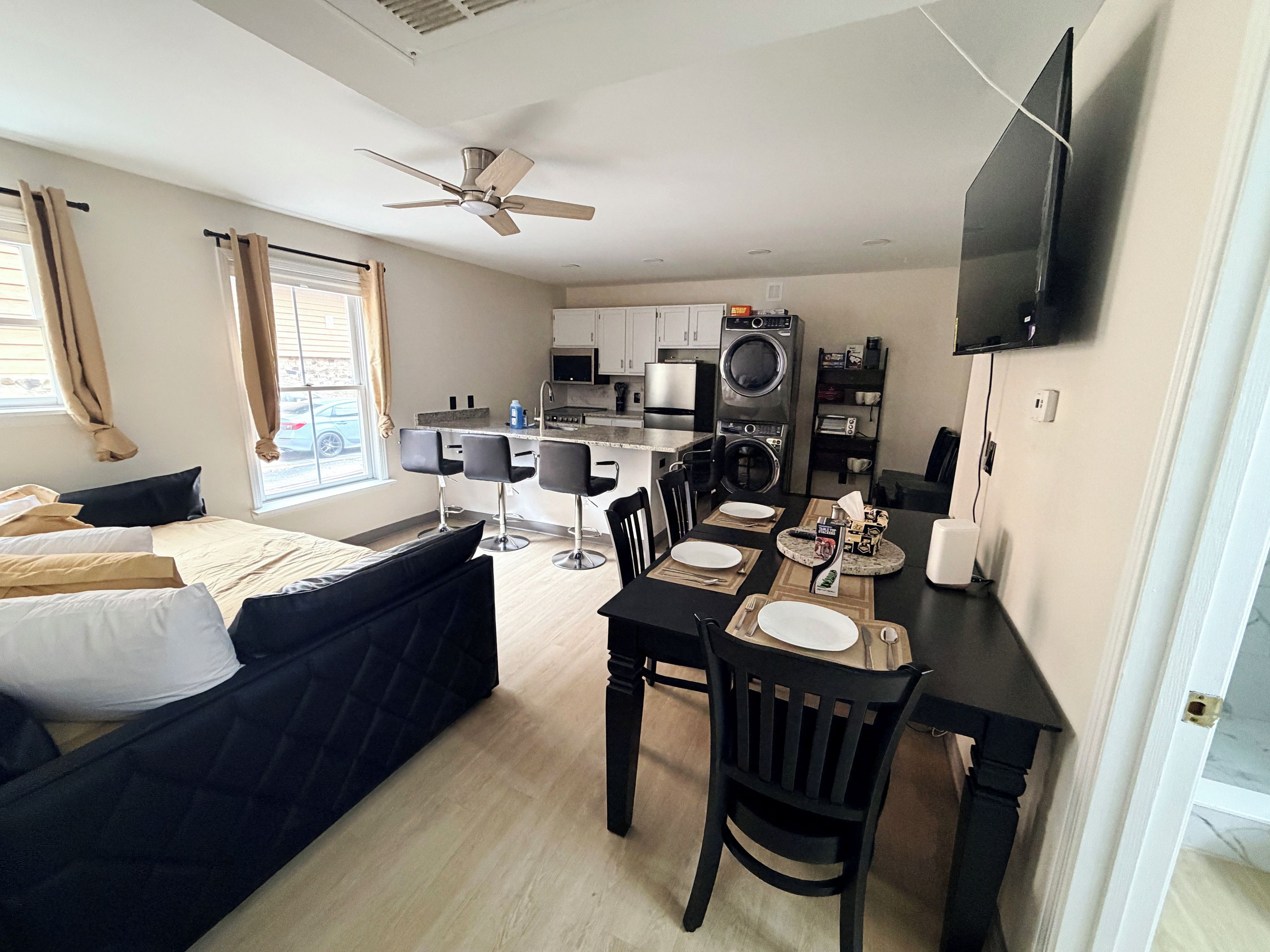 Unit 4 living room includes six-person table, Roku TV, full XL size day bed with twin XL trundle, blackout curtains and blackout window blinds.