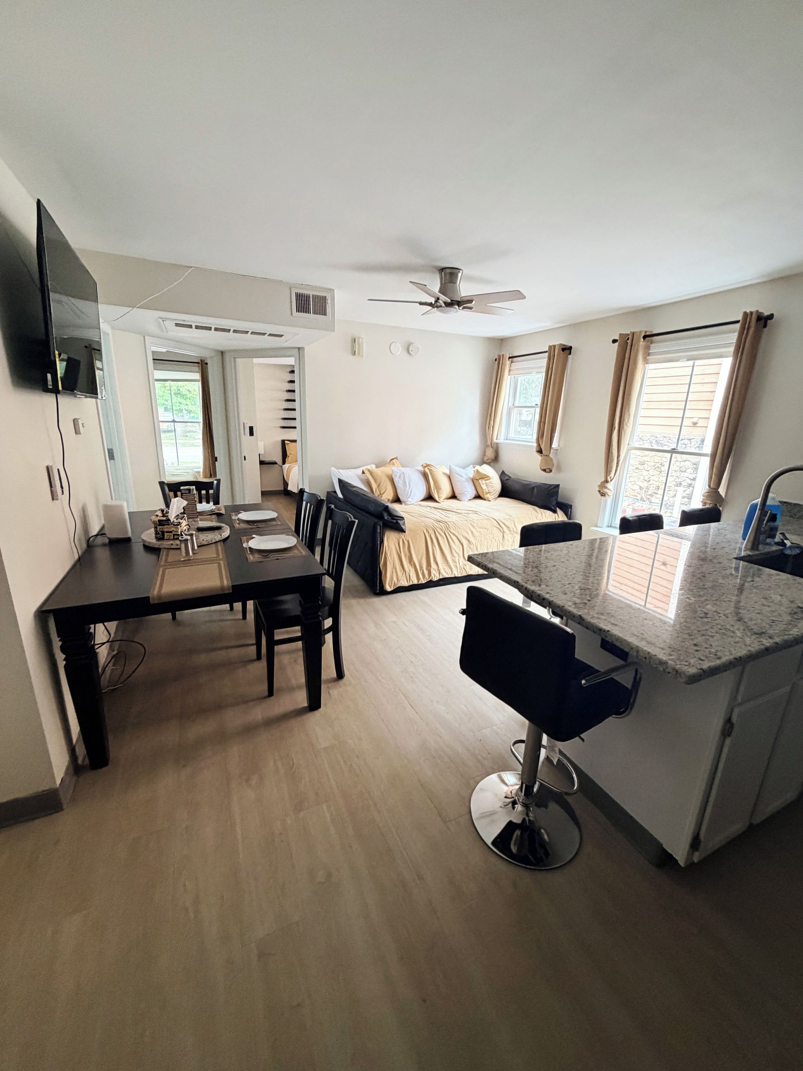 Unit 4 living room includes six-person table, Roku TV, full XL size day bed with twin XL trundle, blackout curtains and blackout window blinds.