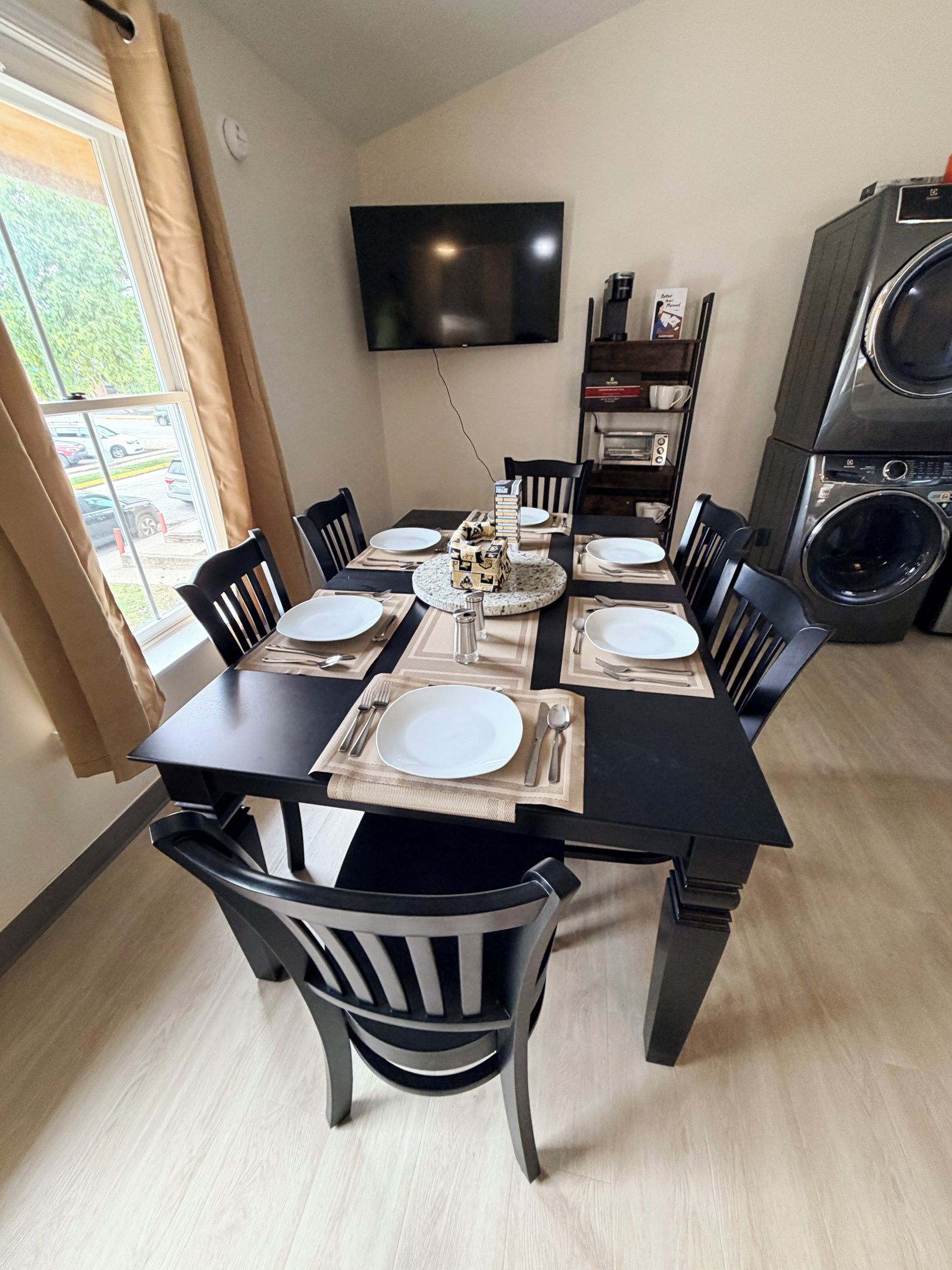 Unit 6 living room includes six person table, Roku TV, full XL size day bed with twin XL trundle, blackout curtains and blackout window blinds.
