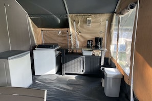 A compact kitchen with a refrigerator, stove, sink, and a small trash bin. - Holiday home in Mol with kettle (Mol)