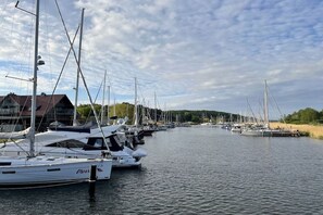 A marina with multiple sailboats docked along the water. - in the Seedorf holiday park (Neuensien- Sellin)