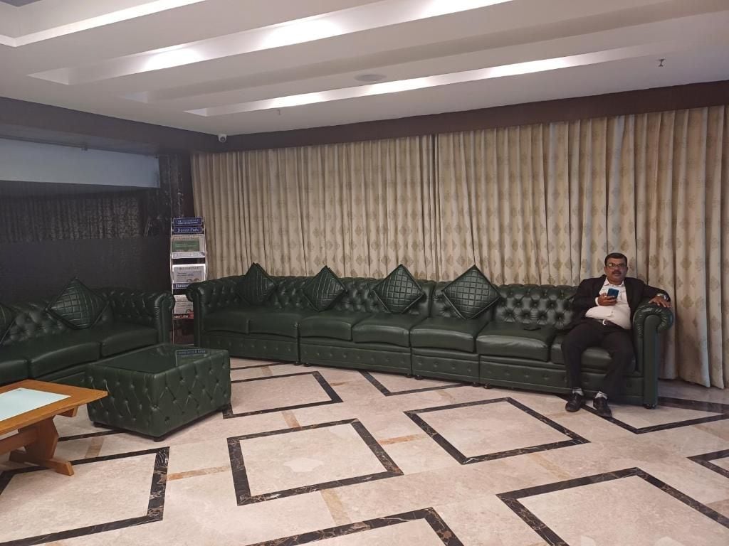Una sala de estar con un sofá modular, una mesa de centro y una alfombra estampada.