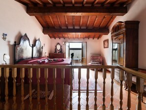 A bedroom with a wooden ceiling, a bed with a headboard, a dresser, and a chair. - Tuscan Retreat, Sun Terrace & Views (Poppi)