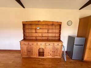 A wooden kitchen with a built-in refrigerator and a clock on the wall. - 1 BlackDyke 3 bedroom house with garden (Hockwold cum Wilton)
