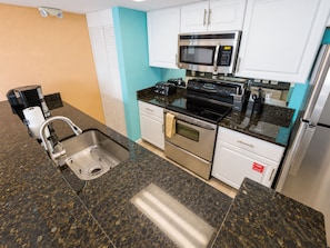 A modern kitchen with stainless steel appliances, a built-in oven, and a microwave. - 2BR Key West condo with pool, hot tub, kitchen, WiFi (Key West)