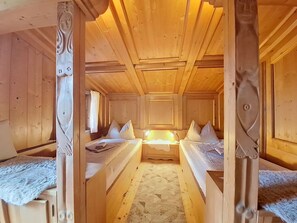 A wooden cabin with two beds, a window, and a bathroom. - Wonderful  villa for 5 people with WIFI, TV and balcony (Kirchberg In Tirol)