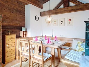 A wooden dining table with chairs, a bench, and a small cabinet. - Stunning  villa for 5 people with WIFI, TV and balcony (Kirchberg In Tirol)