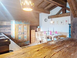 A rustic kitchen with wooden beams, a decorative cabinet, and a dining area with chairs and a table. - Wonderful  villa for 5 people with WIFI, TV and balcony (Kirchberg In Tirol)