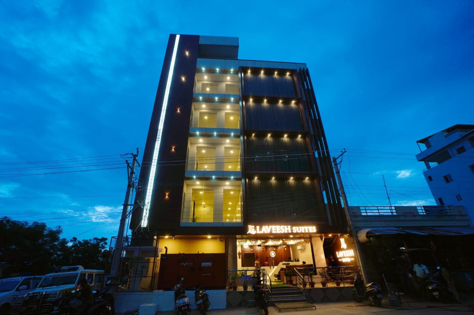 A multi-story building with a prominent sign for 'Laveesh Suites' at the ground level.