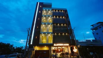 A multi-story building with a prominent sign for 'Laveesh Suites' at the ground level.