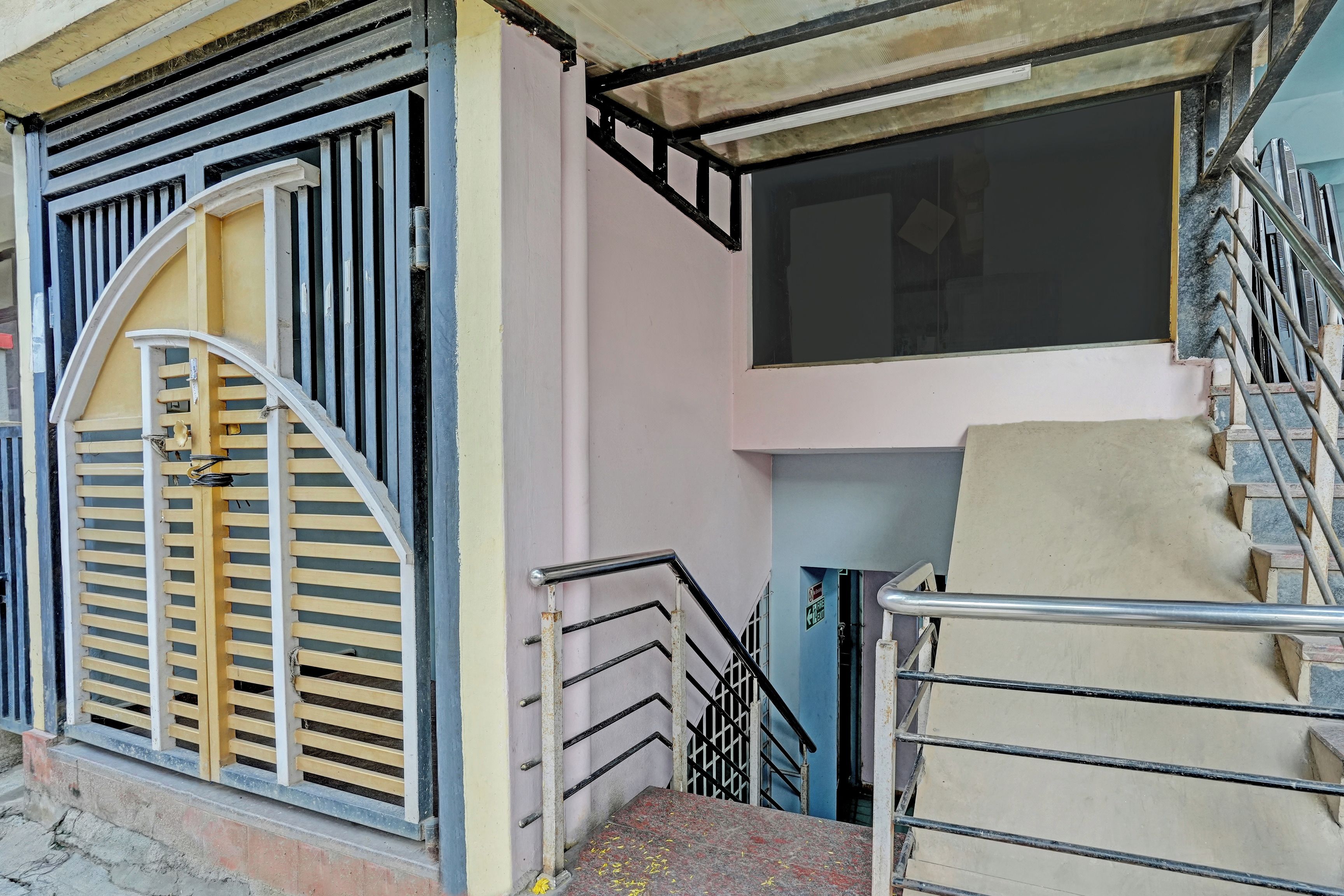 A staircase with metal railings leading to a landing.