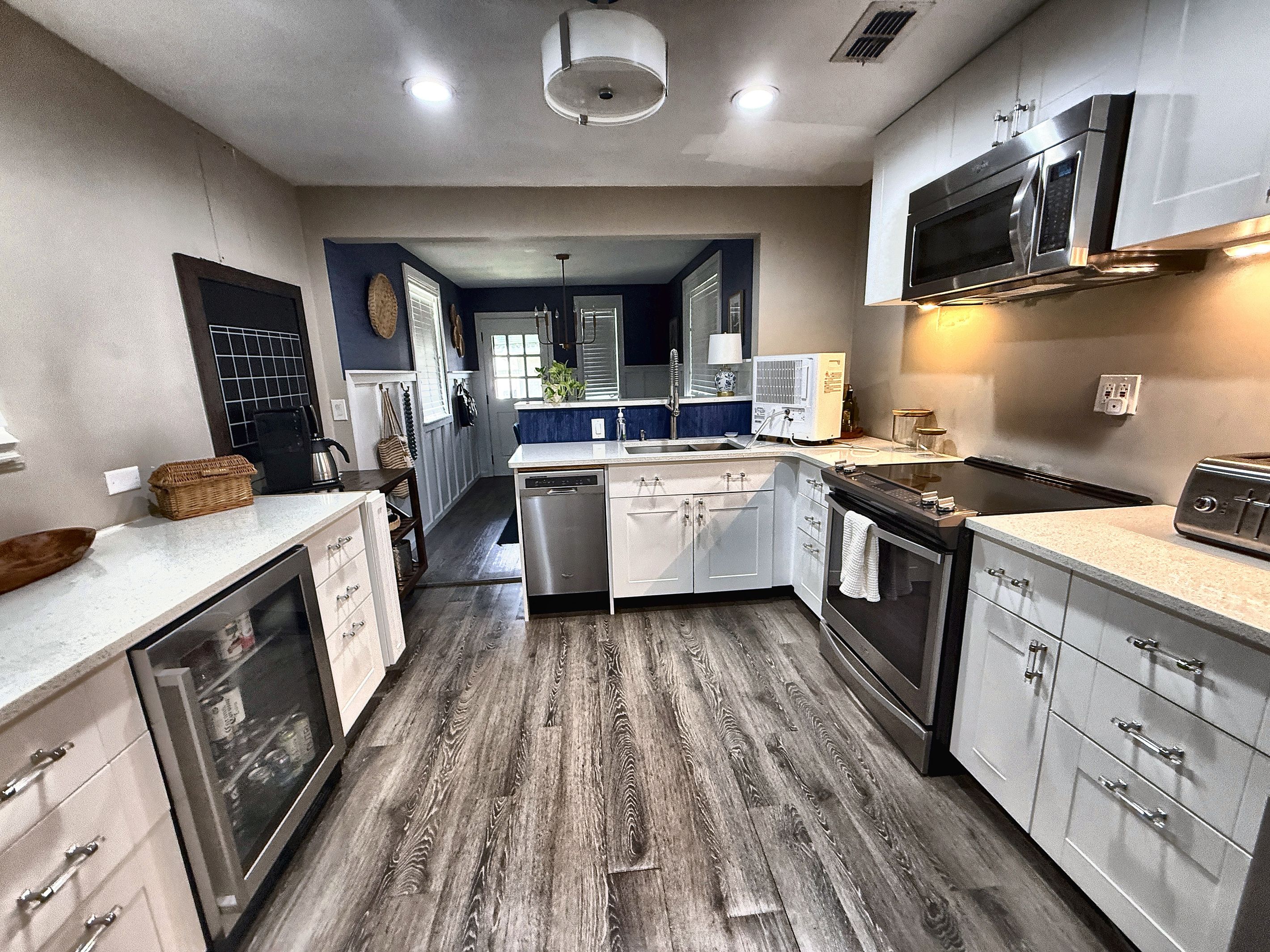 Fully equipped kitchen with stainless-steel appliances, dishwasher, bright white counters and plenty of cabinet space.