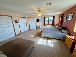 A bedroom with a bed, a chair, a dresser, a television, and a ceiling fan. - Ultimate Family Shore Getaway | 5BR Townhome Sleeps 12 in North Wildwood (North Wildwood)