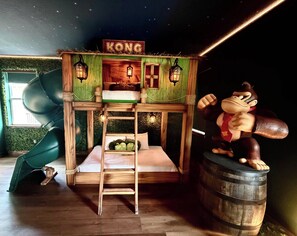 A themed room with a bunk bed, a small slide, and a large plush toy. - Ever After Estate | Luxury 12 Bed Home | 9 mins to Disney World (Kissimmee)