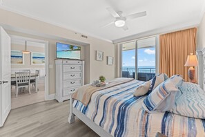 A bedroom with a bed, a dresser, a television, and a view of the ocean. - Elegant Oceanfront Condo, Indoor and Outdoor Pools | Mar Vista Grande - 1511 (North Myrtle Beach)